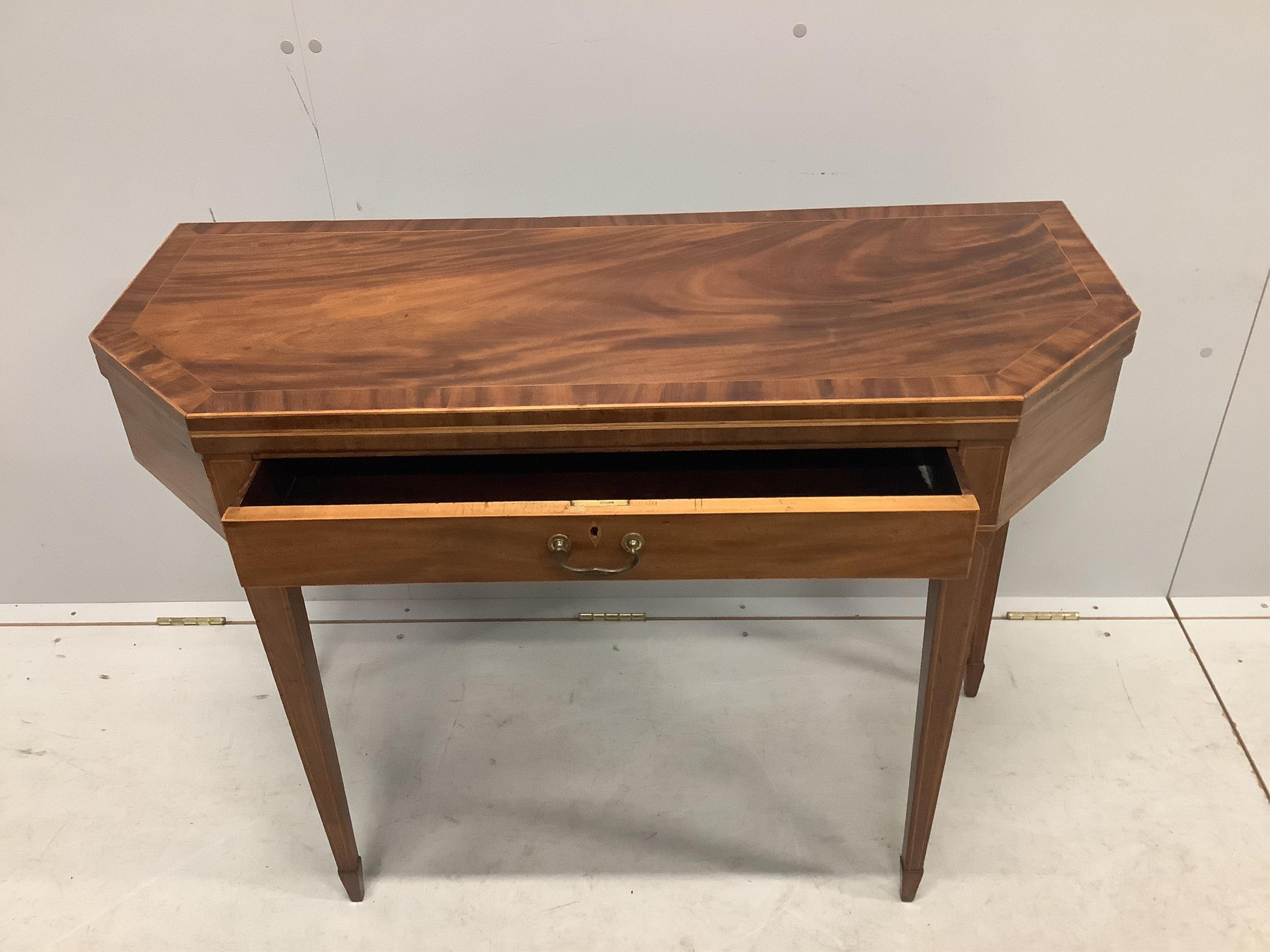 A George III mahogany folding tea table with frieze drawer, width 101cm, depth 41cm, height 73cm. Condition - fair to good